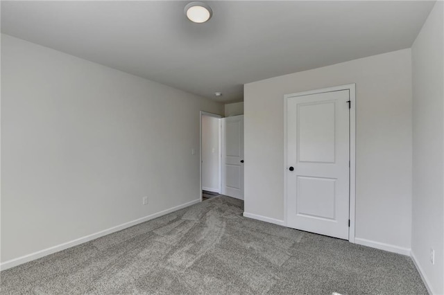 unfurnished bedroom featuring light carpet