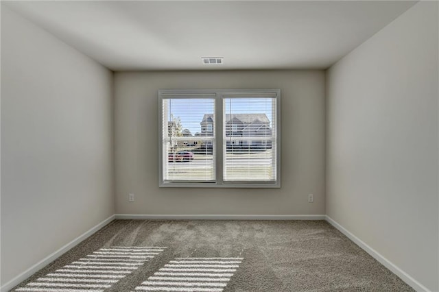 empty room featuring light colored carpet