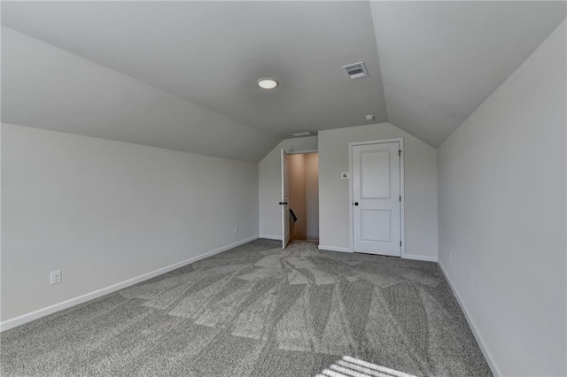 additional living space with vaulted ceiling and light colored carpet