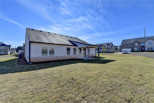 rear view of house with a yard