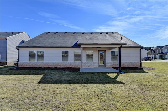 rear view of property featuring a patio area and a lawn