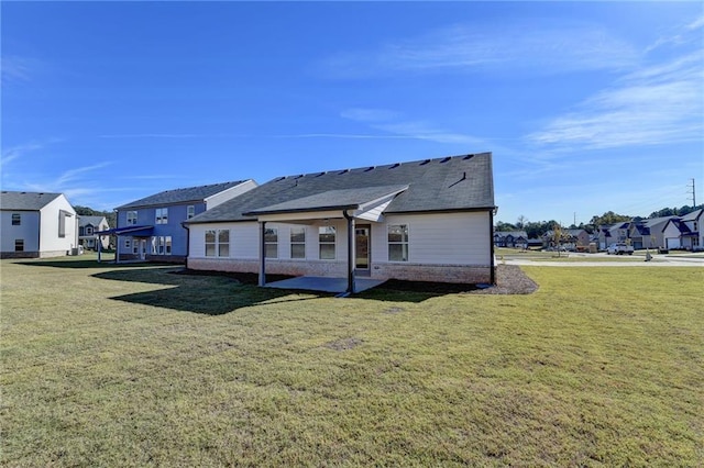 back of house with a lawn