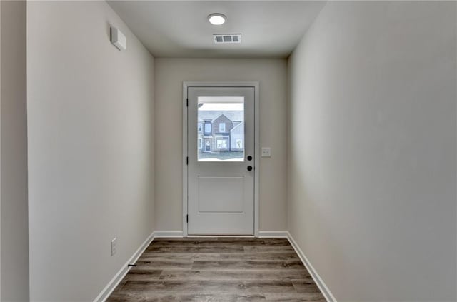 doorway to outside with light wood-type flooring