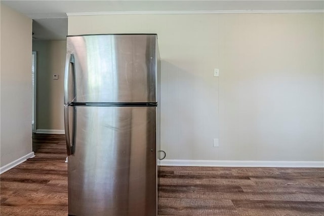 kitchen with wood finished floors, crown molding, freestanding refrigerator, and baseboards