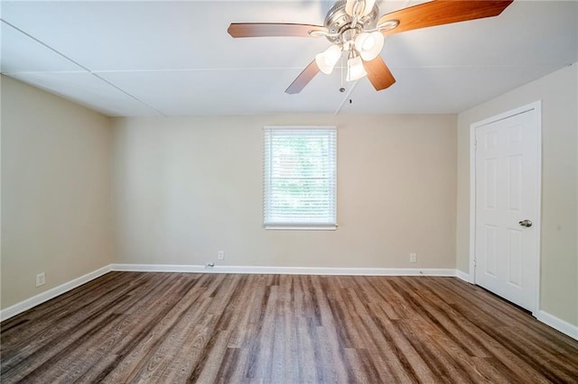 unfurnished room featuring a ceiling fan, wood finished floors, and baseboards