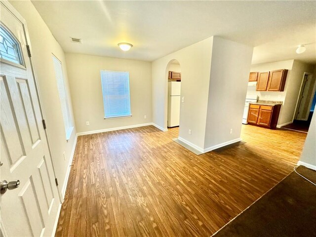 unfurnished living room featuring hardwood / wood-style flooring