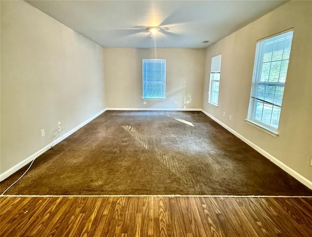 unfurnished room with dark wood-type flooring and ceiling fan