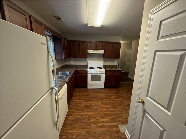 kitchen with white appliances and dark hardwood / wood-style floors