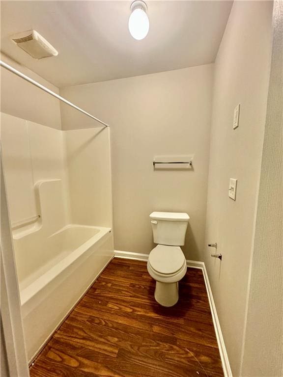 bathroom with hardwood / wood-style floors and toilet