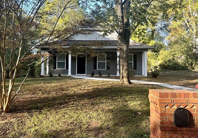 view of front of house featuring a front yard and a porch