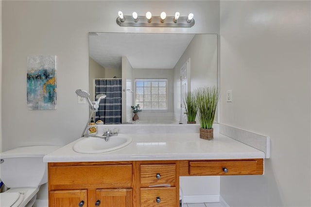 bathroom featuring vanity, toilet, and walk in shower