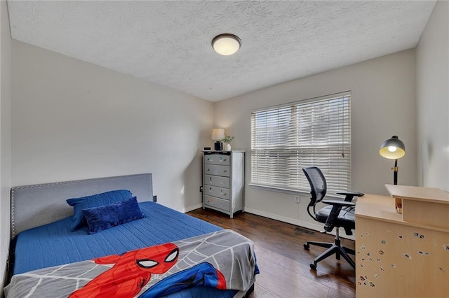 bedroom with dark hardwood / wood-style flooring and a textured ceiling