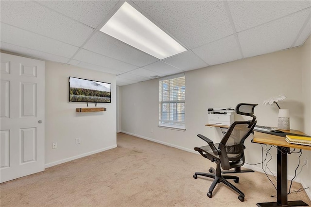 carpeted office space featuring a paneled ceiling