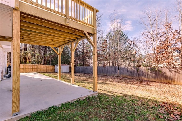 view of yard with a patio area and a wooden deck