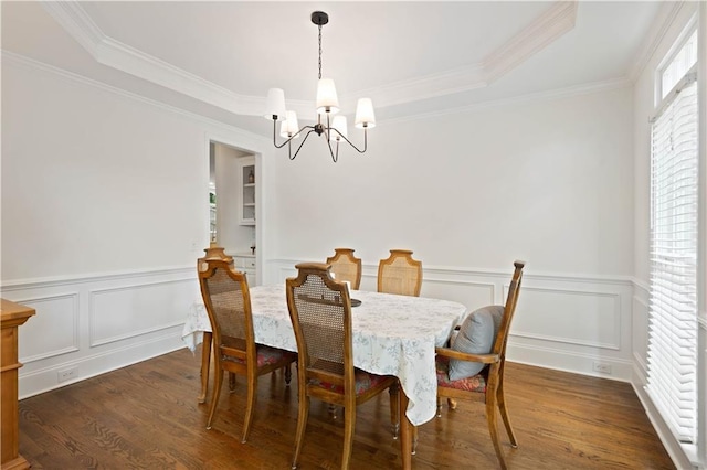 4108 Wyndam Hill Dr, Suwanee, GA 30024 - dining area with a chandelier, dark wood-type flooring, a raised ceiling, ornamental molding, and wainscoting