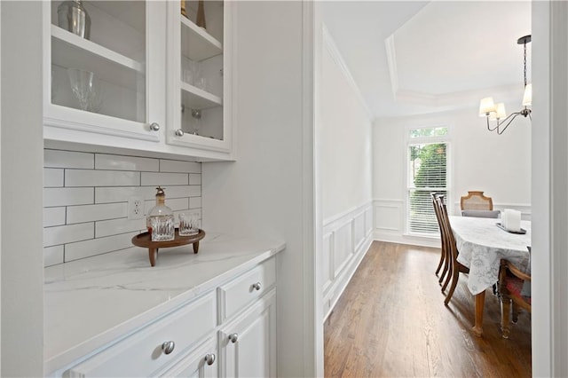 4108 Wyndam Hill Dr, Suwanee, GA 30024 - office space featuring crown molding, a chandelier, a wainscoted wall, a decorative wall, and wood finished floors
