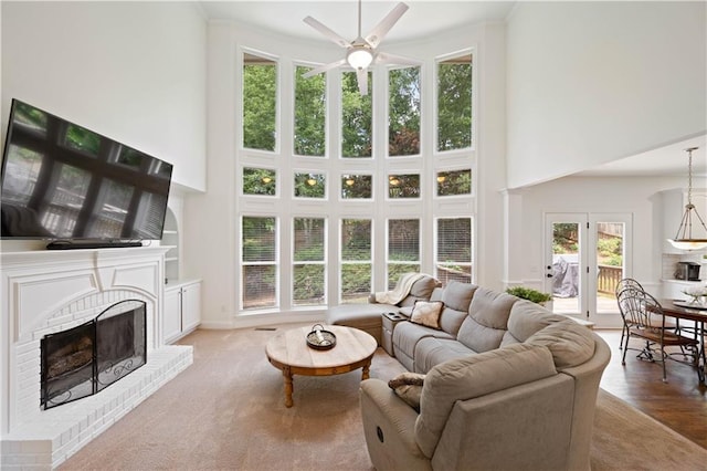 4108 Wyndam Hill Dr, Suwanee, GA 30024 - living area featuring a towering ceiling, ceiling fan, a fireplace, and ornamental molding