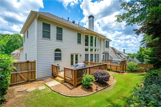 4108 Wyndam Hill Dr, Suwanee, GA 30024 - rear view of house with a chimney and a wooden deck
