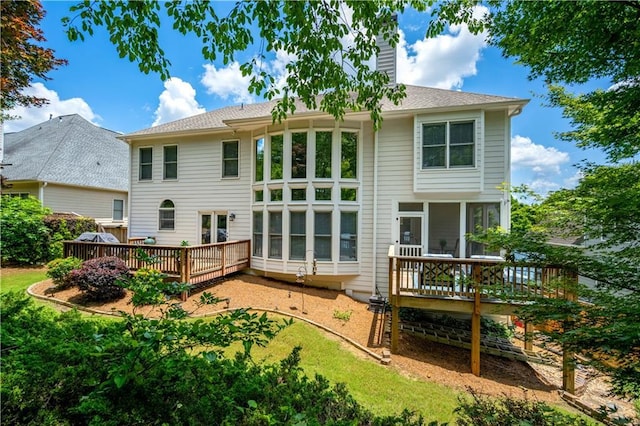 4108 Wyndam Hill Dr, Suwanee, GA 30024 - back of property featuring a wooden deck, a chimney, and a sunroom