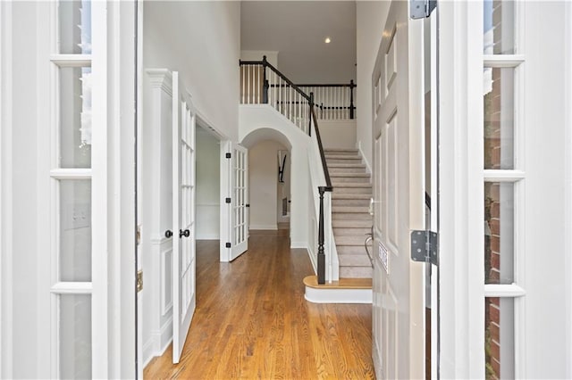 4108 Wyndam Hill Dr, Suwanee, GA 30024 - entrance foyer with french doors, stairs, wood finished floors, arched walkways, and recessed lighting