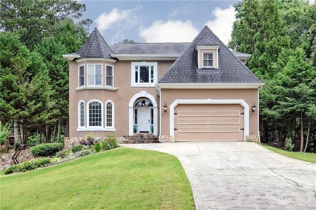 view of front of property with a garage and a front lawn