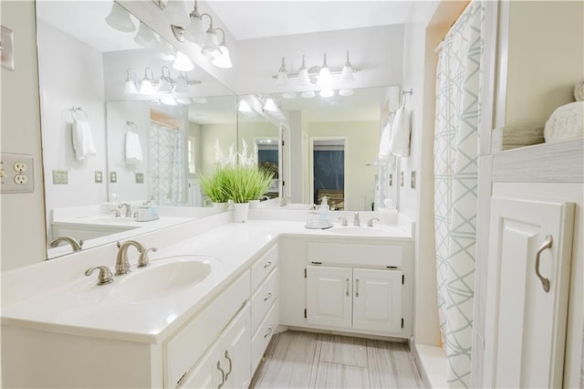 bathroom featuring a sink and double vanity