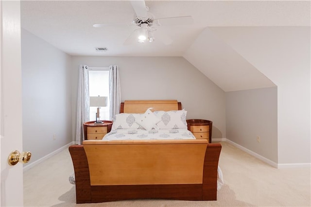 bedroom featuring a ceiling fan, light carpet, vaulted ceiling, and baseboards