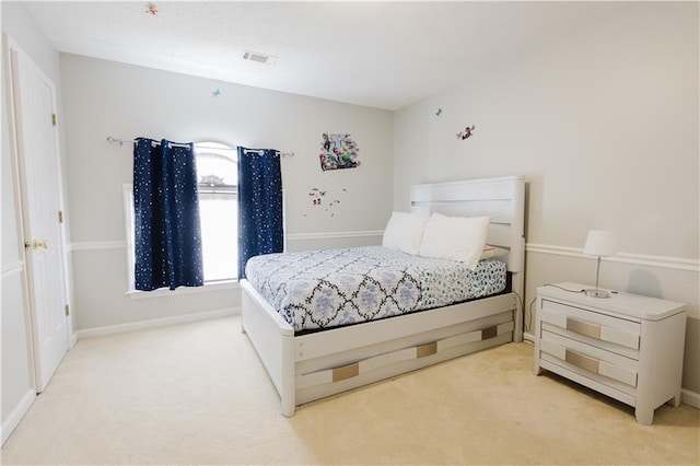 bedroom with baseboards, visible vents, and light colored carpet