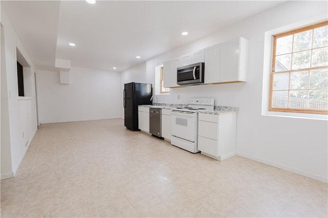 kitchen featuring stainless steel appliances, plenty of natural light, white cabinetry, and recessed lighting