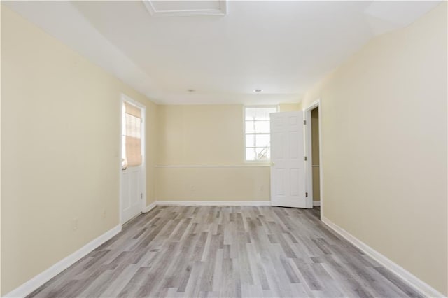 spare room with light wood-style flooring and baseboards