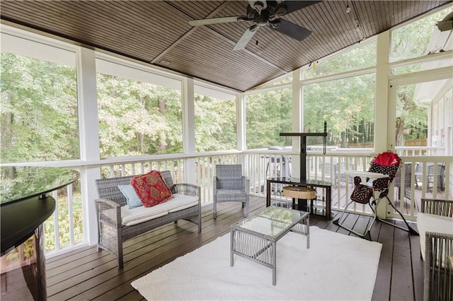 sunroom / solarium with wooden ceiling, vaulted ceiling, and ceiling fan