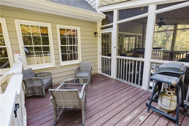 deck with a sunroom and area for grilling