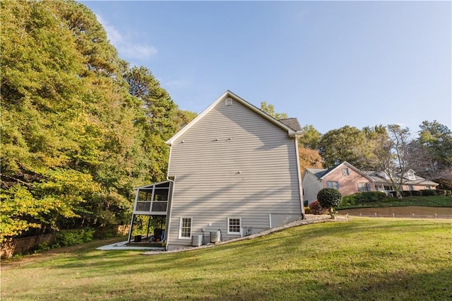 view of side of home with a patio area and a lawn