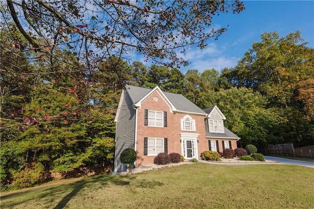 colonial-style house with a front lawn