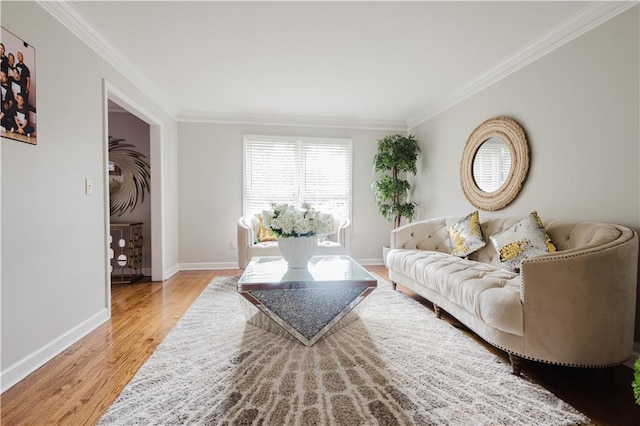 living room with baseboards, wood finished floors, and crown molding