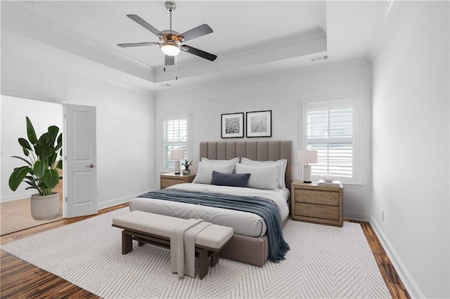 bedroom featuring multiple windows, ceiling fan, and wood-type flooring