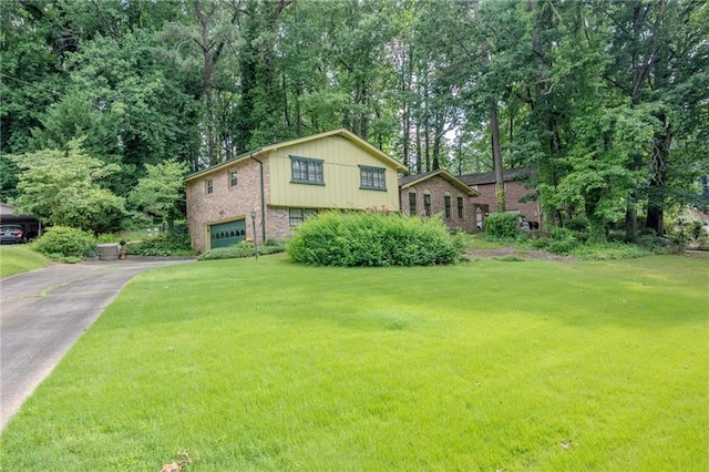 3206 Pyrite Cir SW, Atlanta, GA 30331 - view of front of house with asphalt driveway, an attached garage, a front yard, and brick siding