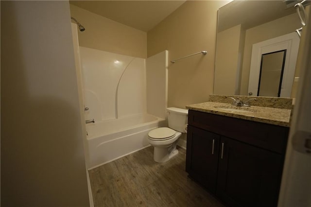 bathroom featuring shower / bathtub combination, vanity, wood finished floors, and toilet