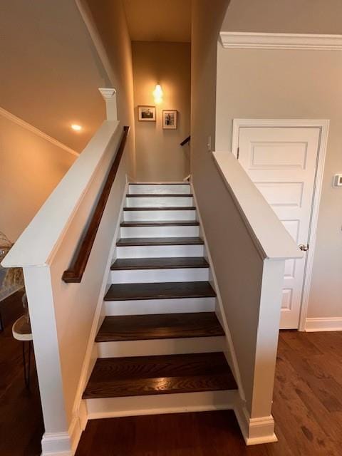 stairway featuring wood finished floors and baseboards