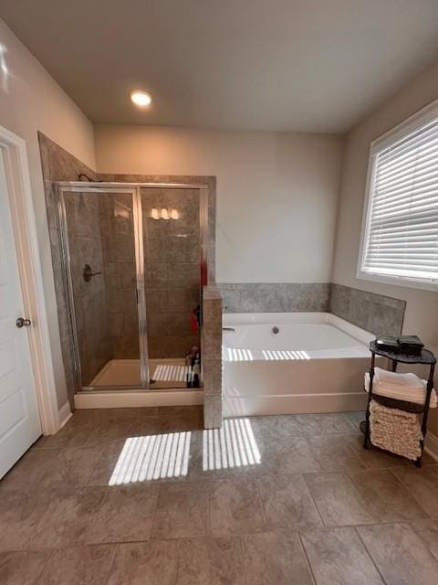 full bath featuring a shower stall and a bath