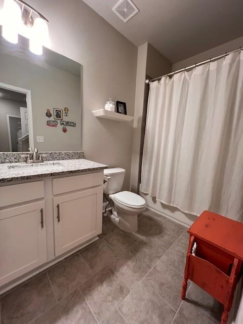 full bath with toilet, visible vents, and vanity