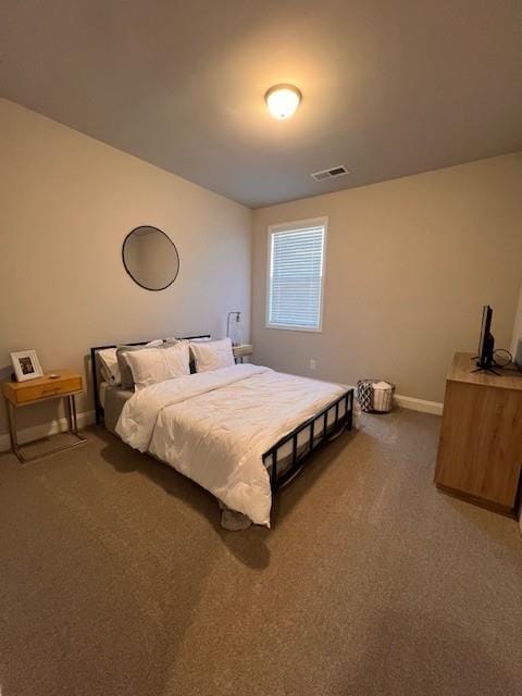 carpeted bedroom with baseboards and visible vents