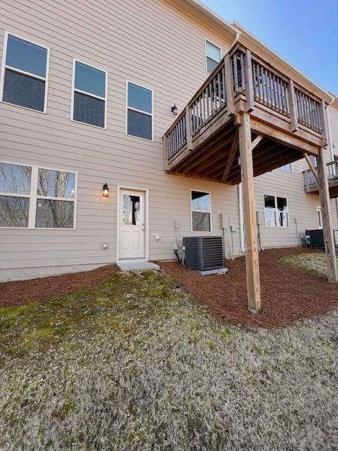 back of property with a deck and central AC unit