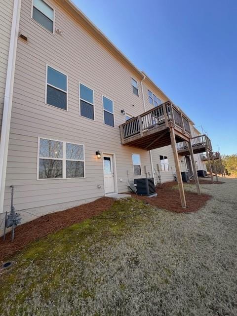 rear view of property with central AC and a deck