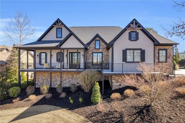 view of front of property with stone siding and a shingled roof