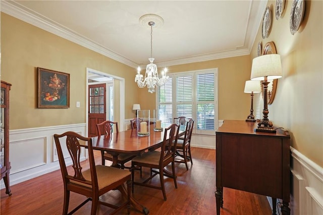 dining area featuring a chandelier, dark hardwood / wood-style floors, and ornamental molding