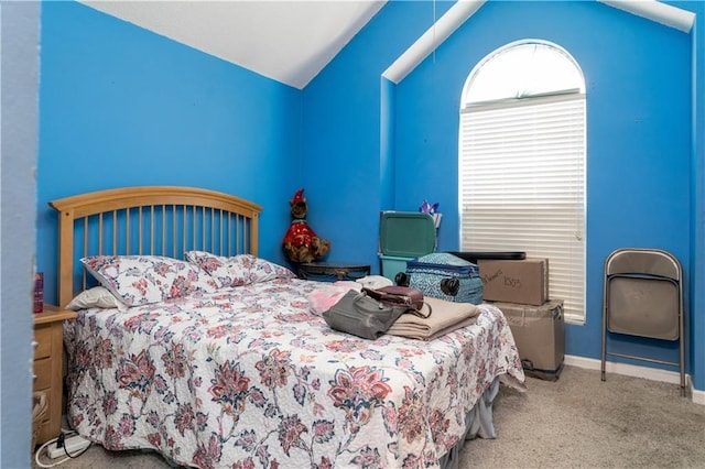 carpeted bedroom featuring lofted ceiling