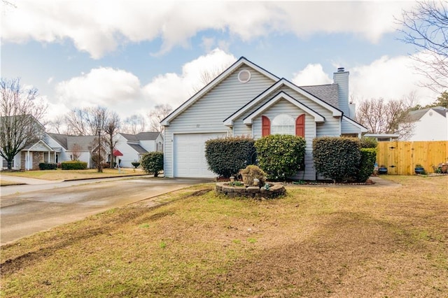 view of front of house featuring a garage and a front lawn