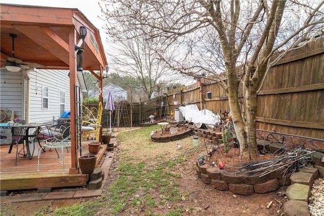 view of yard featuring a wooden deck and ceiling fan