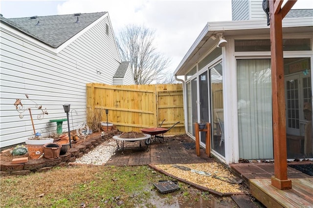 exterior space with an outdoor fire pit and a sunroom